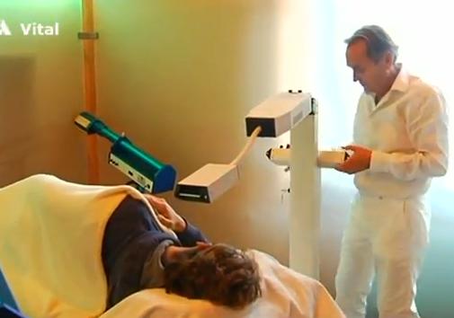 Dr. Wilden adjusts the laser light source for treatment.